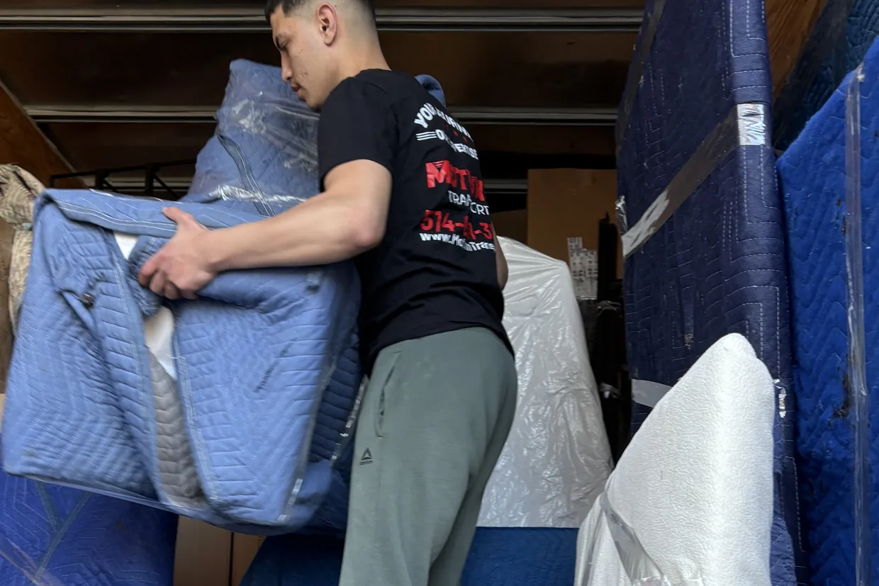 Motion Transport mover carrying folded moving blankets used to protect furniture in transit